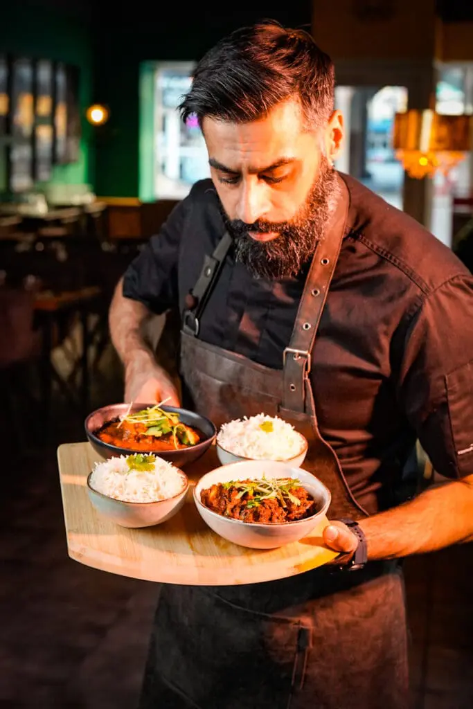 Billede af Abdul med et serveringsbræt til firmaarrangement